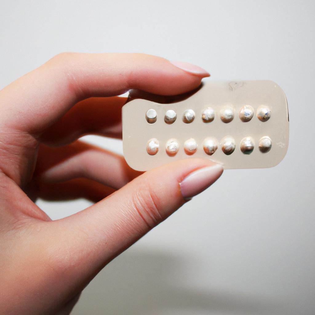 Person holding birth control pill