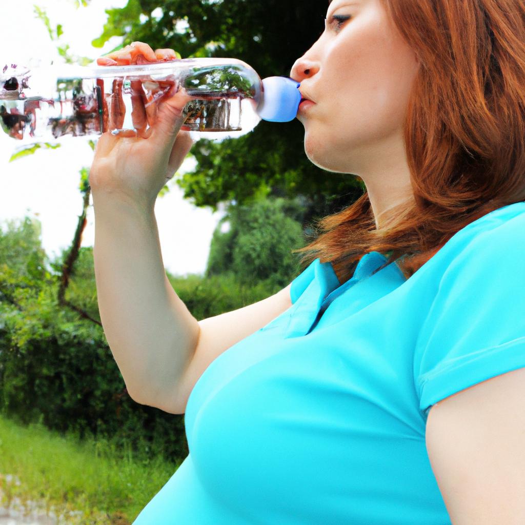 Pregnant woman drinking water bottle