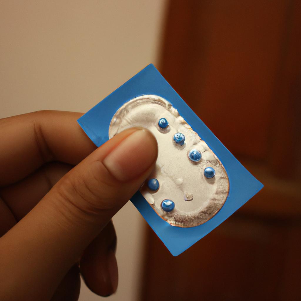 Person holding birth control device