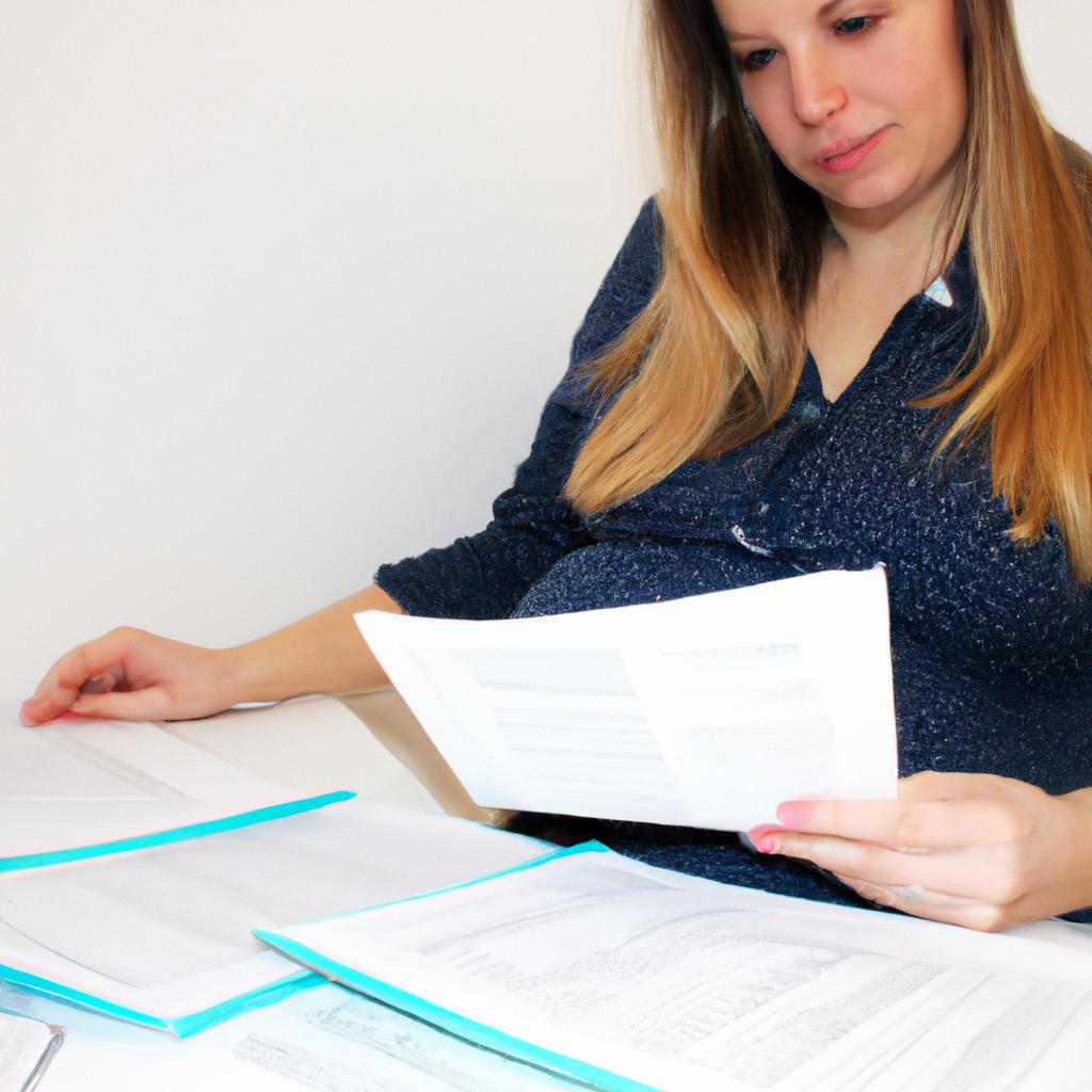 Pregnant woman managing financial documents